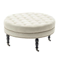 Ottoman de cocktail rond touffeté en tissu avec pieds et roulettes en bois d'hévéa