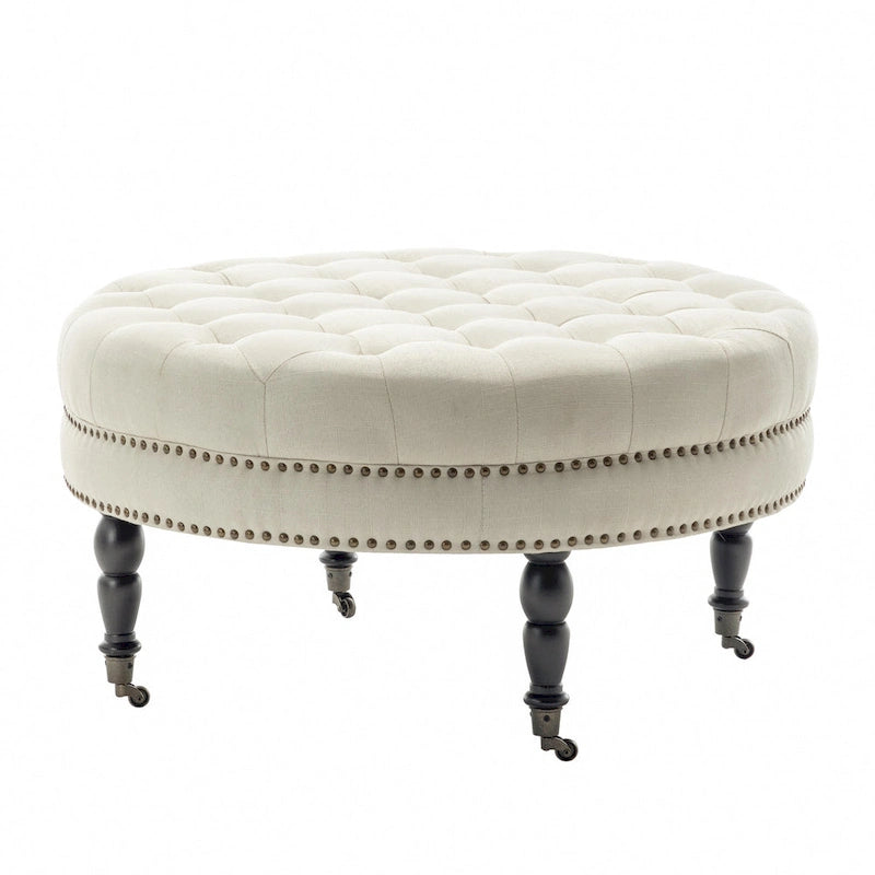 Ottoman de cocktail rond touffeté en tissu avec pieds et roulettes en bois d'hévéa