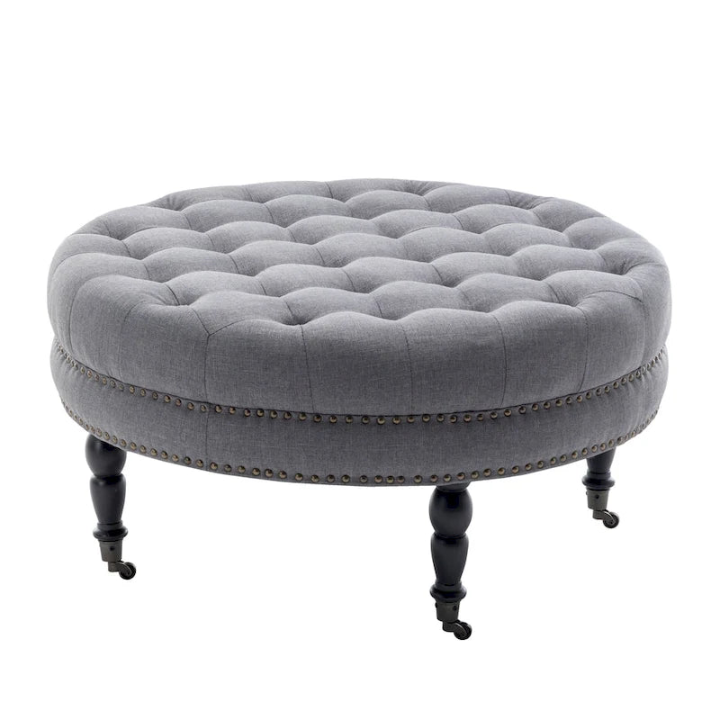 Ottoman de cocktail rond touffeté en tissu avec pieds et roulettes en bois d'hévéa