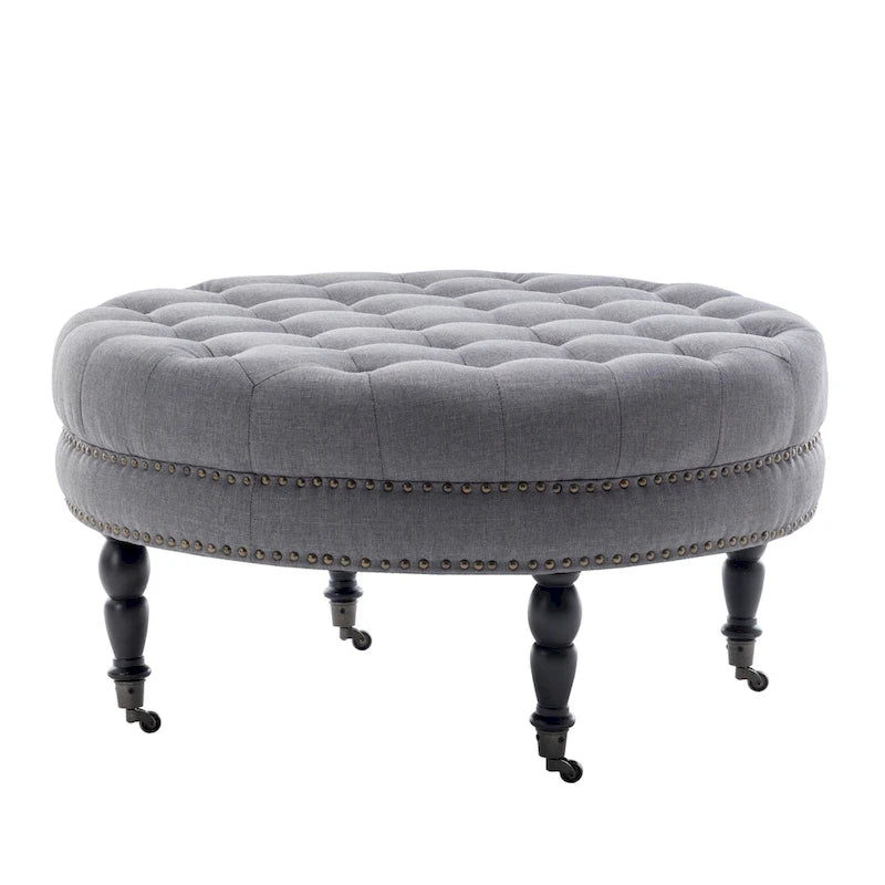 Ottoman de cocktail rond touffeté en tissu avec pieds et roulettes en bois d'hévéa